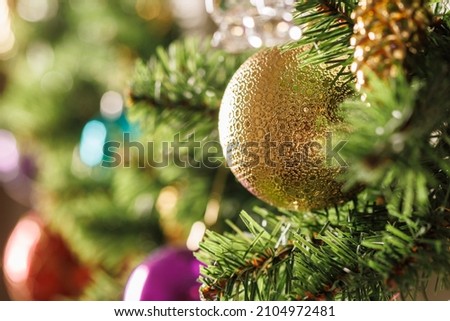 Christmas decorations on an artificial New Year tree. Selective focusing.