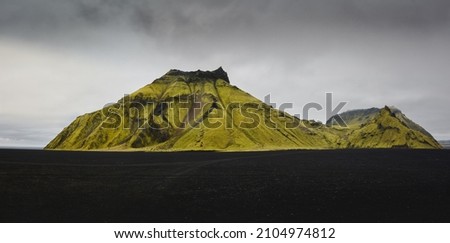 stunning green mossy mountain with black sand, icelandic highlands