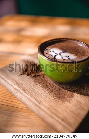 Coffee cup with cream or milk, top view on beautiful wooden background. Great picture for baner or menu