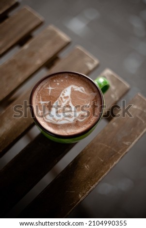 Coffee cup with cream or milk, top view on beautiful wooden background. Great picture for baner or menu