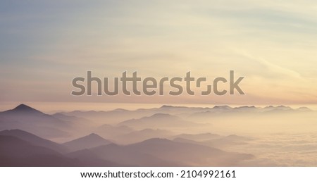 Majestic sunset in the mountains.The natural light of the sun fell on the horizon. Natural background Royalty-Free Stock Photo #2104992161