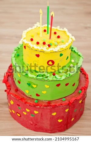 Lithuanian flag color cake. Paper birthday cake painted with gouache. Decorated with punch paper and other home made decorations and glitter.