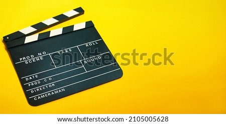 A clapperboard, symbol of filmmaking and video production. Professional type of equipment, used on films to assist in synchronizing of picture and sound