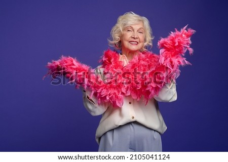 Energetic elegant woman with a feather boa on her shoulder Royalty-Free Stock Photo #2105041124