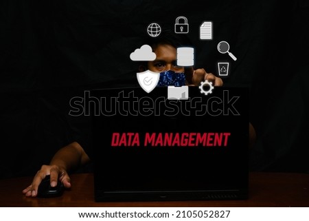 A picture of data management process with symbol and man with laptop insight.