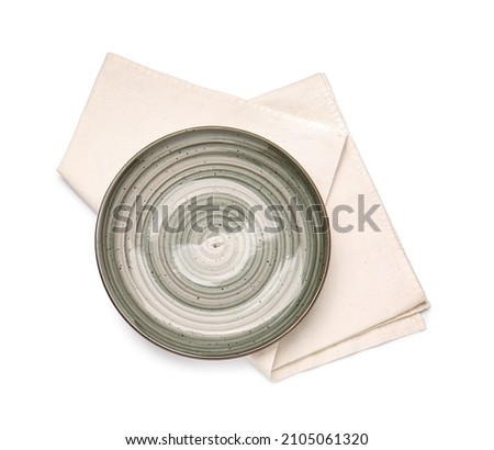 Clean napkin and plate on white background