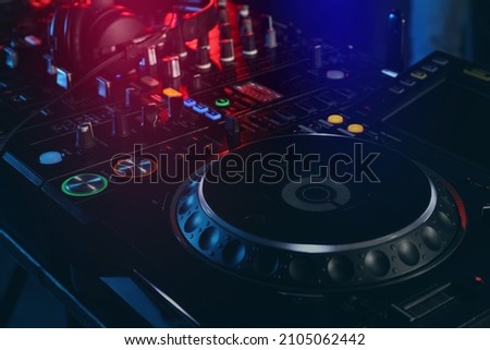 Closeup view of modern DJ controller with headphones
