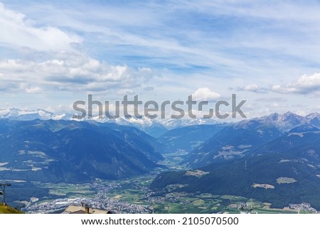 A beautiful view of Kronplatz (Plan de Corones) with mountain range in background, Italy