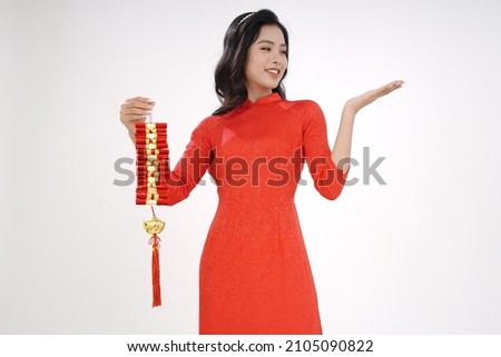 Vietnamese young lady in traditional robe for Lunar New Year Festival Season Royalty-Free Stock Photo #2105090822