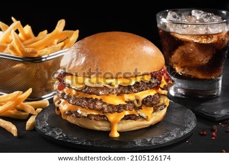 Smash burger with fries in black backgraund Royalty-Free Stock Photo #2105126174
