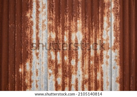 Full frame shot of a weathered and rusty corrugated iron roof, suitable as a industrial background texture Royalty-Free Stock Photo #2105140814