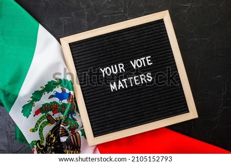 Letterboard sign with the words your vote matters with Mexico  flag on  black background