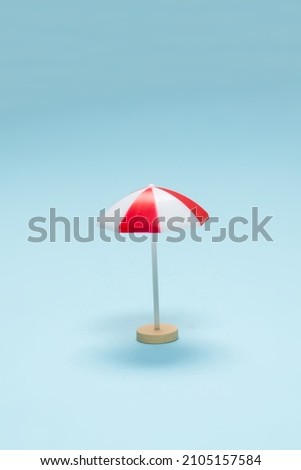 Red umbrella on a blue background. Copy space.