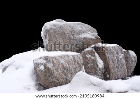 natural stone in snow isolated on black background. High quality photo