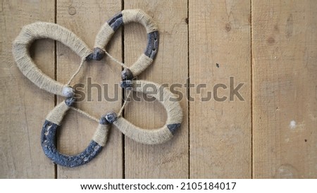 DIY handmade trefoil clover from horseshoes for your daily luck in a gras background  Royalty-Free Stock Photo #2105184017