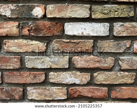Old brick wall background, brick wall texture, structure. old broken brick, cement joints, close-up. crumbling from old age. construction, repair. concept of devastation, decline. High quality photo Royalty-Free Stock Photo #2105225357