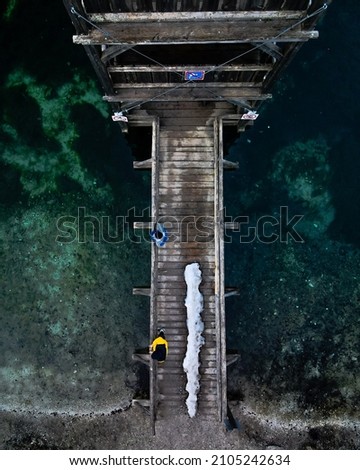 Two people standing on a footbridge at a Lake in Slovenia