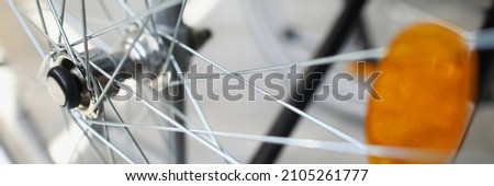 Close-up of bicycle wheel. Comfy and fast vehicle. Popular type of transport for walk. Macro shot of silver needles. Bike maintenance and repair service concept