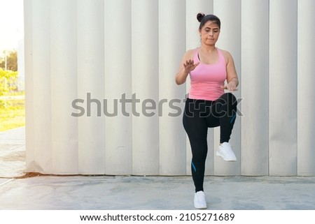 Latin Woman During Stretching Exercise Outdoors In The Park