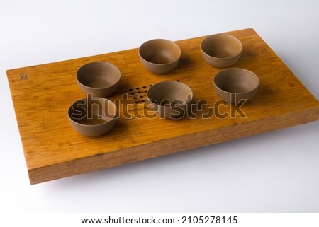 A set of six traditional cups for oriental tea drinking on a wooden table for tea ceremonies. Space for copy. Traditional Asian ceramic cup.