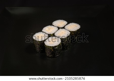 Set of Different Sushi and Rolls over Black Background