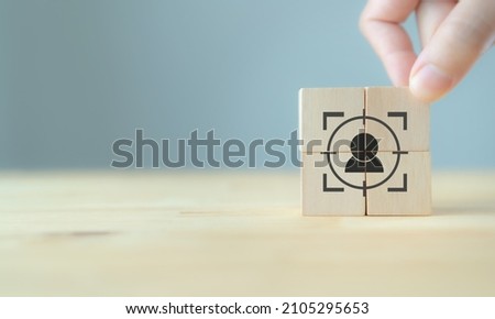 Personalized marketing concept. Customer behavior and persona. Customization strategy.  Customer centric. Hand put the wooden cubes focused on personalization icon on grey backgroud and copy space.