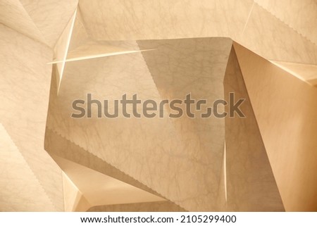 Sheets of cardboard resembling modern architecture fragment with wall and ceiling surfaces. Abstract industrial background. Geometric pattern with triangular and polygonal structure of panels.