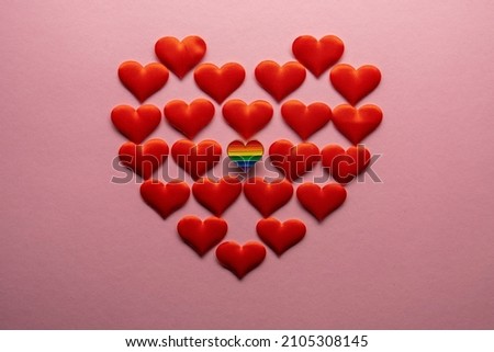 Heart shaped badge with Lgbt gay rainbow flag on pink background. LGBT Valentine's day concept.