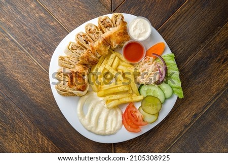 shawarma with chicken in Arabic on wooden table top view Royalty-Free Stock Photo #2105308925
