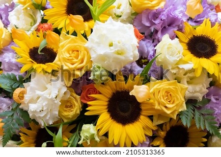 A lot of sunflowers and white roses