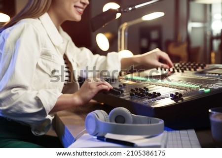 Woman working as radio host in modern studio, closeup