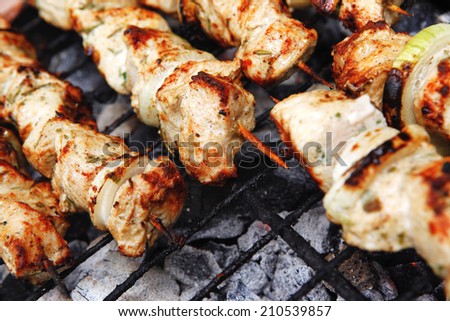 healthy shish kebab - grilled bbq chicken turkish meat on skewers over charcoal brazier outdoor