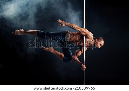 Male Pole Dance Athlete Royalty-Free Stock Photo #210539965