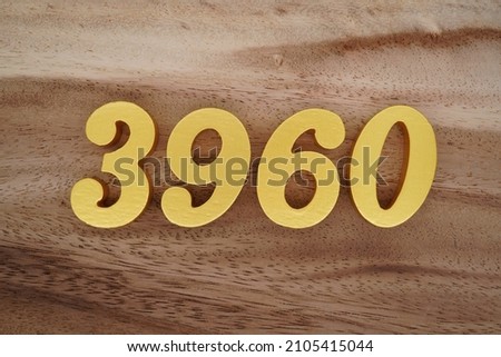 Golden Arabic numerals 3960 on a dark brown to white wood grain background.