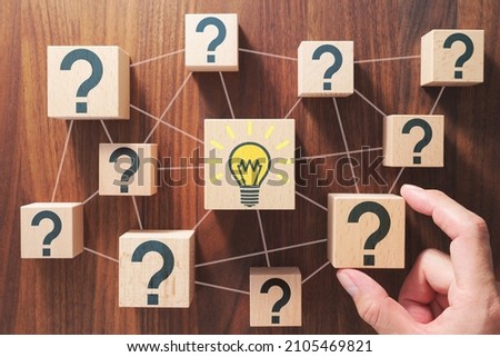 Finding solution concept. Breaking question into several pieces. Putting wood cubes with question marks.  
 Royalty-Free Stock Photo #2105469821