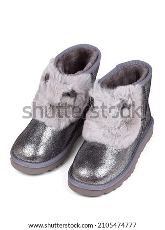 Silver winter woman's boots with fur on a white background.