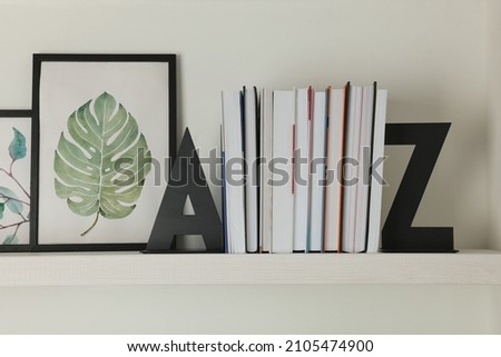 Bookends with books and pictures on shelf indoors