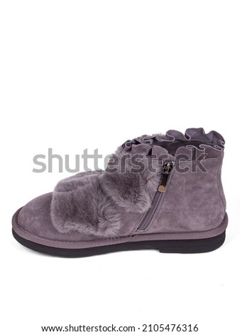 Purple winter woman's boots with fur on a white background.