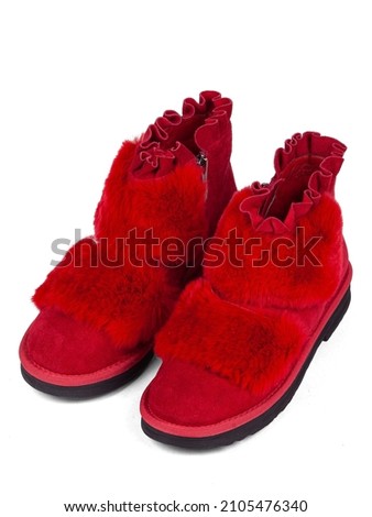Red winter woman's boots with fur on a white background.