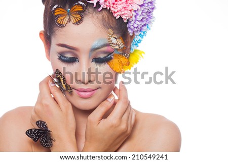 Asian Beautiful Girl With colorful make up with fresh Flowers and Butterfly. Beauty Face,head and shoulder,with white background,in studio light