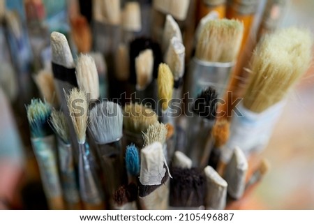 Tubes of oil paint, palette and artist paintbrushes closeup Royalty-Free Stock Photo #2105496887