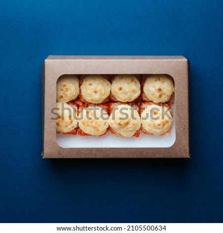 delicious lunch sushi in box on blue background