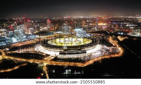Aerial drone night shot of iconic illuminated London Stadium in Queen Elisabeth park at Christmas, London, United Kingdom