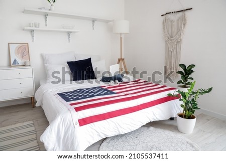 Interior of stylish bedroom with USA flag