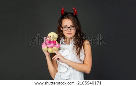 Devil in love. Devil girl hold Valentines bear. Halloween party. Halloween from the dark side