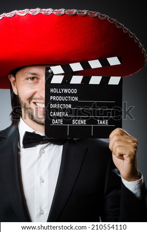 Mexican man with movie board clapboard
