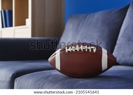 Rugby ball on blue sofa, closeup