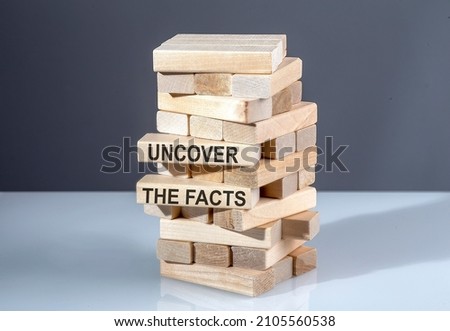 The text on the wooden blocks UNCOVER THE FACTS Royalty-Free Stock Photo #2105560538