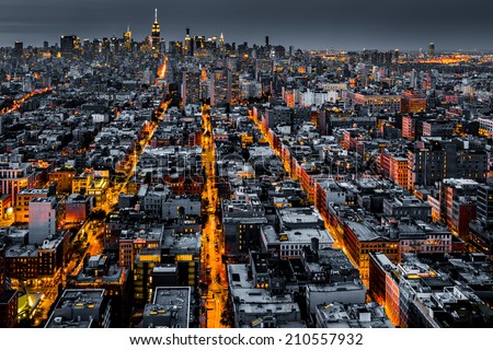 Aerial view of New York City at night with illuminated avenues converging towards midtown. Royalty-Free Stock Photo #210557932