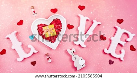 Valentine's Day, Mother's Day, March 8, World Women's Day holiday card concept. Flat lay. word love in white letters on a trendy pink background.
